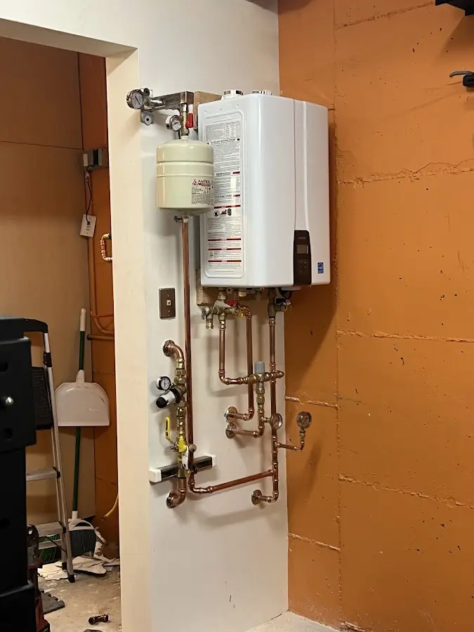 Plumbing technician inspecting water heater connections in Aberdeen